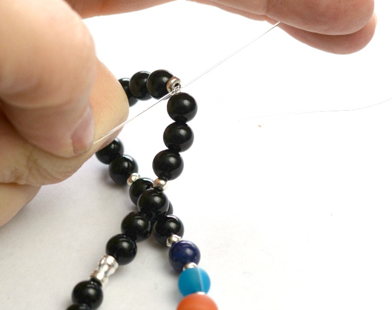 DIY Solar System bracelet at happyhourprojects.com | This DIY features gemstone beads and pewter elements on a simple stretch cord. A fun DIY and a great science lesson too! #science #space #DIY #jewelry